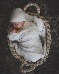 Swaddled baby in a basket